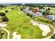 Expansive aerial view of a luxury community located on a golf course, complete with lush landscapes and serene surroundings at 7649 Heritage Crossing Way # 302, Reunion, FL 34747
