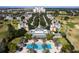 Aerial view of the community featuring a central clubhouse, pool, and residential buildings at 7649 Heritage Crossing Way # 302, Reunion, FL 34747