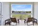 Balcony with seating offers views of the golf course and community buildings at 7649 Heritage Crossing Way # 302, Reunion, FL 34747