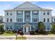 Stunning condo exterior boasts classic architecture, blue accents, and well-maintained landscaping at 7649 Heritage Crossing Way # 302, Reunion, FL 34747