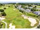 Scenic view of the green golf course surrounding beautiful blue and white condo building at 7649 Heritage Crossing Way # 302, Reunion, FL 34747