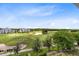 Elevated view showing the expansive golf course, surrounding condos, and blue skies at 7649 Heritage Crossing Way # 302, Reunion, FL 34747
