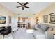 Open-concept living room featuring a kitchen bar and comfortable seating area with neutral tones and ample natural light at 7649 Heritage Crossing Way # 302, Reunion, FL 34747