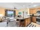 Inviting living room flows into kitchen, has patio access, and comfortable seating arrangement at 7649 Heritage Crossing Way # 302, Reunion, FL 34747