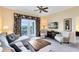 Cozy living room with balcony access, comfortable seating, and stylish decor at 7649 Heritage Crossing Way # 302, Reunion, FL 34747