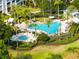 Beautiful swimming pool and spa surrounded by palm trees and lush landscaping, perfect for relaxation at 7649 Heritage Crossing Way # 302, Reunion, FL 34747