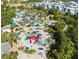 Aerial view of a vibrant water park with slides, pools, and recreational areas amidst lush landscaping at 7649 Heritage Crossing Way # 302, Reunion, FL 34747