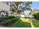 Lush green lawn with tropical foliage landscaping around the house's white picket fence at 910 Cypress Ave, St Cloud, FL 34769