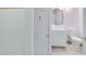 Compact bathroom featuring white fixtures, tile flooring and classic design elements at 910 Cypress Ave, St Cloud, FL 34769