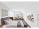 Sunlit bedroom with neutral tones, large window, and playful decor at 910 Cypress Ave, St Cloud, FL 34769