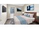 Cozy bedroom with carpet floors, a nature scene television display, and a white-beige color palette at 910 Cypress Ave, St Cloud, FL 34769