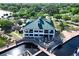 A beautiful clubhouse featuring a green metal roof, covered outdoor seating, and boat access at 910 Cypress Ave, St Cloud, FL 34769