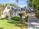 Charming yellow two-story home with a well-manicured lawn and a three car garage at 910 Cypress Ave, St Cloud, FL 34769