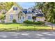 Charming yellow home with a manicured lawn and well-maintained landscaping at 910 Cypress Ave, St Cloud, FL 34769