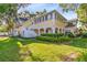 View of the side and rear of the home, showing the lush green lawn at 910 Cypress Ave, St Cloud, FL 34769