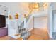 Elegant foyer featuring a staircase with white railings and beautiful hardwood floors at 910 Cypress Ave, St Cloud, FL 34769
