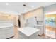 Well-lit kitchen boasts white cabinets, center island, modern appliances, and tile floors at 910 Cypress Ave, St Cloud, FL 34769