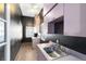 Spacious laundry room featuring neutral tile flooring, pink cabinets and dark colored walls at 910 Cypress Ave, St Cloud, FL 34769