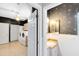 View of laundry room with modern washer and dryer units plus a half-bathroom off to the side at 910 Cypress Ave, St Cloud, FL 34769