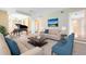 Spacious living room with comfortable seating, piano, and bright natural light at 910 Cypress Ave, St Cloud, FL 34769