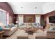 Cozy living room with plush seating, elegant decor, and a vaulted ceiling at 910 Cypress Ave, St Cloud, FL 34769