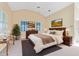 Bright main bedroom with vaulted ceiling, large window, and neutral decor at 910 Cypress Ave, St Cloud, FL 34769
