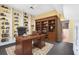 Well-appointed office with built-in bookshelves, a large desk, and ample storage at 910 Cypress Ave, St Cloud, FL 34769