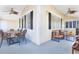 Outdoor patio with seating and dining areas, ceiling fans, and neutral tones at 910 Cypress Ave, St Cloud, FL 34769