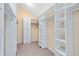 Large walk-in closet with custom shelving, storage, and organization system at 910 Cypress Ave, St Cloud, FL 34769