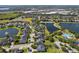Expansive aerial shot of a suburban community featuring tranquil lakes, pools, and neighborhood streets at 922 Home Grove Dr, Winter Garden, FL 34787