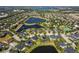 Sprawling aerial view of a residential community with lush greenery, lakes, and private pools at 922 Home Grove Dr, Winter Garden, FL 34787