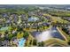 Wide aerial view featuring a lakefront community and amenities like a community pool and park at 922 Home Grove Dr, Winter Garden, FL 34787