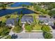 Aerial view of a neighborhood showcasing well-manicured lawns, mature trees, and tranquil waterfront living at 922 Home Grove Dr, Winter Garden, FL 34787