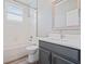Bathroom with single sink vanity, mirror, and shower-tub combo at 922 Home Grove Dr, Winter Garden, FL 34787