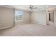 Spacious bedroom featuring a ceiling fan, neutral paint, carpet and a window with plantation shutters at 922 Home Grove Dr, Winter Garden, FL 34787
