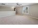 Carpeted bonus room with a ceiling fan, neutral paint, and a window with plantation shutters at 922 Home Grove Dr, Winter Garden, FL 34787