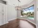 Well-lit dining room with a large bay window overlooking the pool and outdoor seating area at 922 Home Grove Dr, Winter Garden, FL 34787