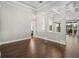 Dining room featuring hardwood floors, decorative columns, modern lighting, and access to an outdoor dining area at 922 Home Grove Dr, Winter Garden, FL 34787