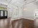 Open-concept living room featuring hardwood floors, decorative columns, and contemporary lighting, creating a spacious feel at 922 Home Grove Dr, Winter Garden, FL 34787
