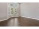 Bright living room with large windows and hardwood floors, providing ample natural light and open space at 922 Home Grove Dr, Winter Garden, FL 34787