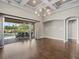 Living room featuring coffered ceilings and sliding glass doors that lead to the backyard pool area at 922 Home Grove Dr, Winter Garden, FL 34787