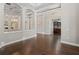 Spacious living room with hardwood floors, decorative columns, and a view into a study, creating an inviting space at 922 Home Grove Dr, Winter Garden, FL 34787