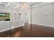 Living room with hardwood floors, decorative columns, and view of an outdoor pool, blending indoor and outdoor living at 922 Home Grove Dr, Winter Garden, FL 34787