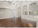 Bright living room with arched openings, a modern light fixture, and beautiful hardwood flooring at 922 Home Grove Dr, Winter Garden, FL 34787