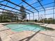 Screened pool area featuring two hanging lounge chairs and an umbrella with manicured landscaping at 922 Home Grove Dr, Winter Garden, FL 34787