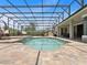 Screened pool featuring two hanging lounge chairs, an umbrella, and manicured landscaping at 922 Home Grove Dr, Winter Garden, FL 34787