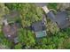 Aerial view of a property in a wooded area with an in-ground pool in the backyard at 934 Deerwood Loop, Longwood, FL 32779