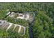 Wide aerial shot of the property highlighting parking, buildings, green spaces and waterfront kayak rentals at 934 Deerwood Loop, Longwood, FL 32779