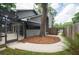 Home's landscaped backyard with gated access to the screened in pool and patio area at 934 Deerwood Loop, Longwood, FL 32779