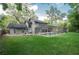 Relaxing screened-in pool area surrounded by a green lawn is perfect for outdoor enjoyment and entertaining at 934 Deerwood Loop, Longwood, FL 32779